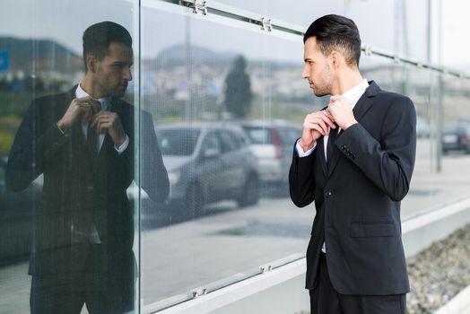 Portrait of a young businessman near a office building