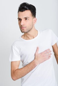 Portrait of a smart serious young man standing against white background