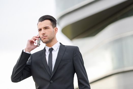 Portrait of an attractive young businessman on the phone in an office building