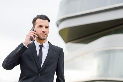 Portrait of an attractive young businessman on the phone in an office building