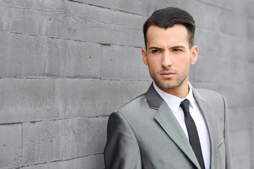 Portrait of a young businessman near a office building