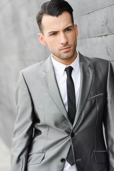 Portrait of a young businessman near a office building