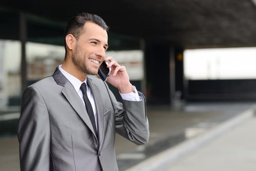 Portrait of an attractive young businessman on the phone in an office building