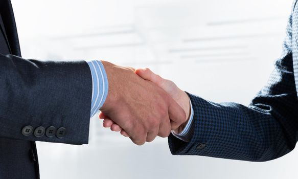 A close-up of a handshake. Making a deal between two businessmen