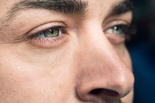 Close-up shot of man's eye. Man with blue eyes.