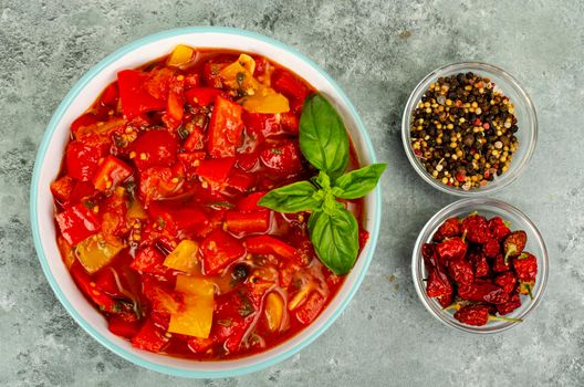 Vegetable dish of stewed sweet peppers and tomatoes, lecho, vegetarian menu. Studio Photo