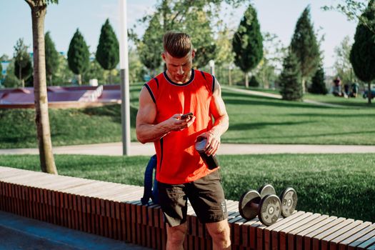 athletic man in red t-shirt in fitness park. High quality photo