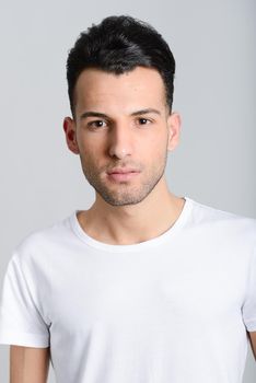 Portrait of a smart serious young man standing against white background