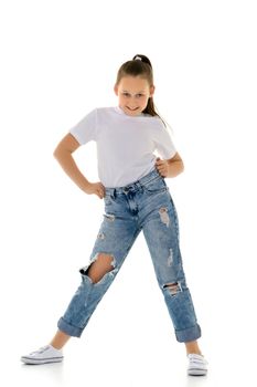 Beautiful teen girl in jeans with holes. Concept of happy childhood, fashion and style. Isolated on white background.
