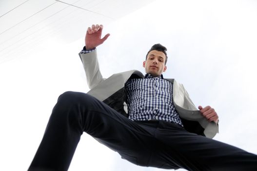 Portrait of a young handsome man, model of fashion, jumping and wearing jacket and shirt