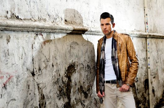 Portrait of a young handsome man in urban background