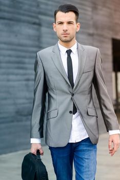 Portrait of a young businessman near a office building