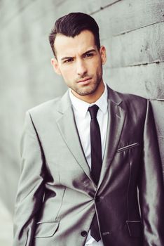 Portrait of a young businessman near a office building