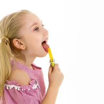 Cute little girl with great pleasure licks a candy. Happy childhood concept. Isolated over white background.