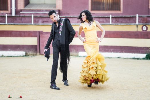 Portrait of a pretty couple, models of fashion, in a bullring. Spanish style