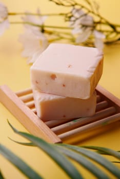 Homemade natural soap bar on black background .