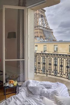 Window view of the Eiffel Tower with breakfast