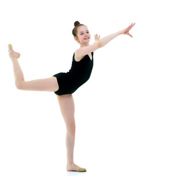 A girl gymnast performs an acrobatic element. The concept of childhood, sport, healthy lifestyle. Isolated on white background.