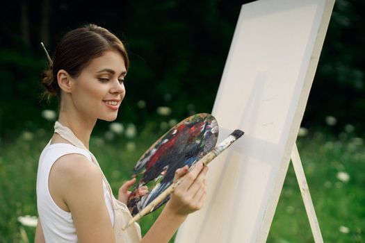 woman outdoors paint a picture landscape hobby creative. High quality photo