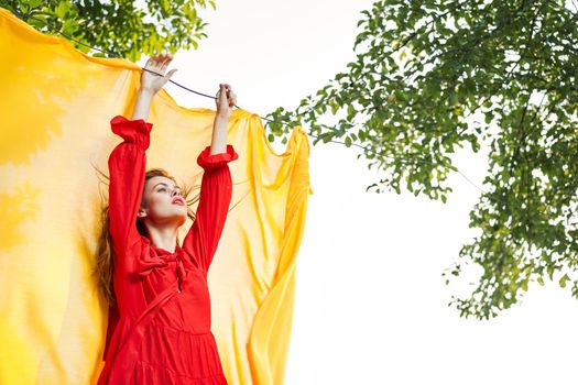 woman in red dress outdoors yellow bedspread. High quality photo