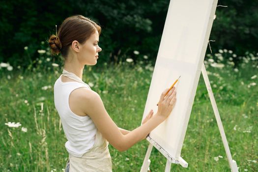 women outdoors near easel creative art drawing. High quality photo