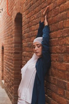 Portrait of a Muslim woman posing outdoors. Modern islamic female concept.