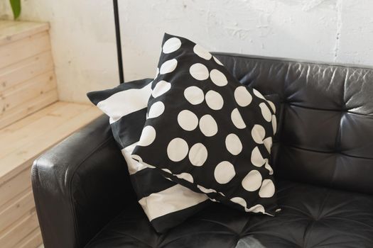 Black and white cushions on a sofa. Modern furniture.