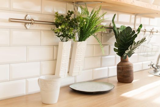 Home interior of a trendy, stylish, bright Scandinavian-style kitchen with open shelves. Loft interior.