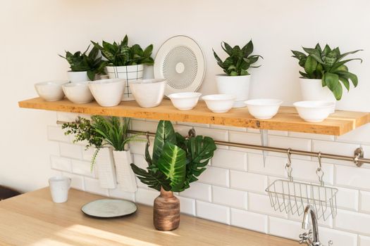 Home interior of a trendy, stylish, bright Scandinavian-style kitchen with open shelves. Loft interior.