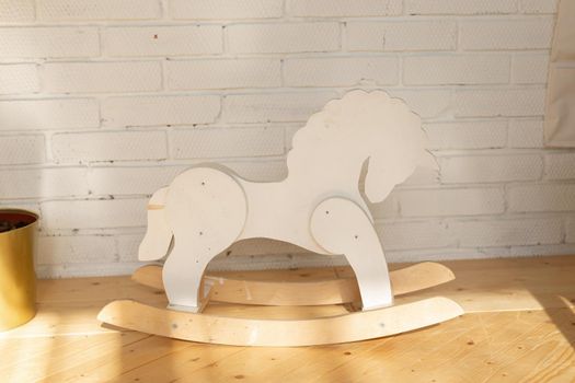 Cute vintage classic rocking horse chair for children could enjoy the riding on white room.