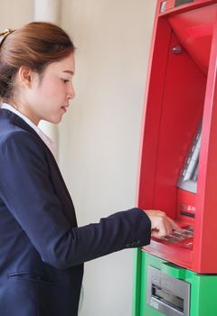 female business hand entering PIN/pass code on ATM/bank machine keypad
