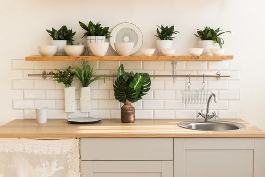 Home interior of a trendy, stylish, bright Scandinavian-style kitchen with open shelves. Loft interior.