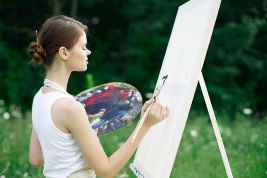 woman artist nature paints palette easel creative landscape. High quality photo