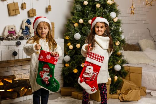 christmas, x-mas, winter, happiness concept - two adorable girls playing.