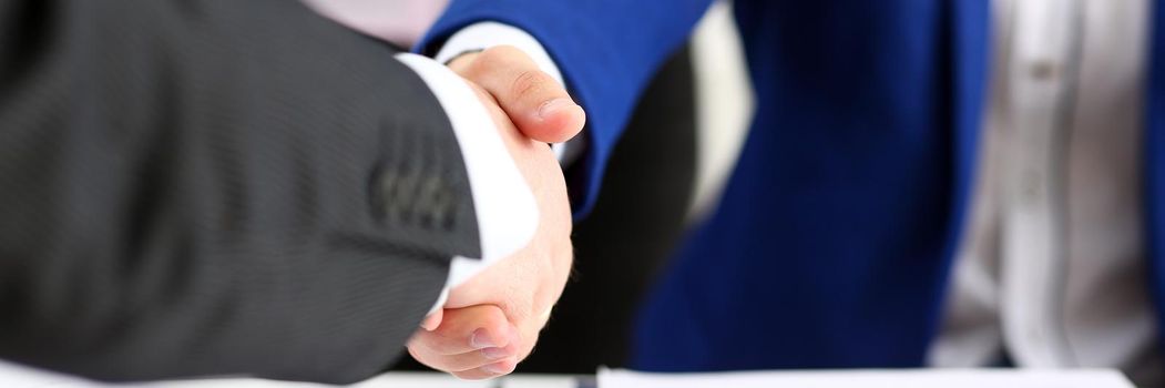 Man in suit shake hand as hello in office closeup. Friend welcome, mediation offer, positive introduction, greet or thanks gesture, summit participate approval, motivation, strike arm bargain concept