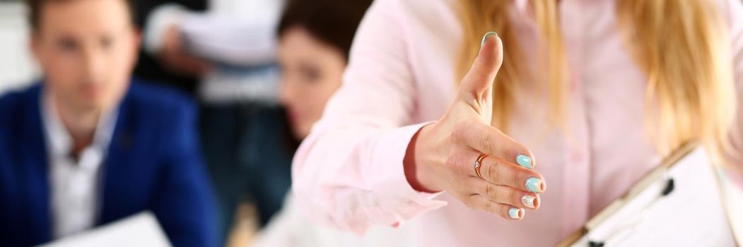 Businesswoman offer hand to shake as hello in office closeup. Serious business, friendly support service, excellent prospect, introduction or thanks gesture, gratitude, invite to participate concept