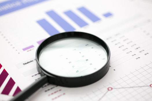 Financial statistics documents with lens at office table closeup. Internal Revenue Service inspector sum check, irs investigation, exchange market, earnings, savings, loan and credit concept