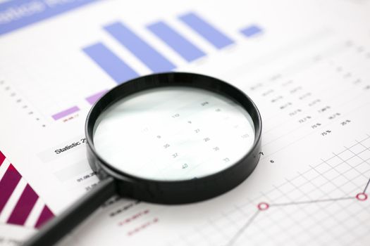 Financial statistics documents with lens at office table closeup. Internal Revenue Service inspector sum check, irs investigation, exchange market, earnings, savings, loan and credit concept