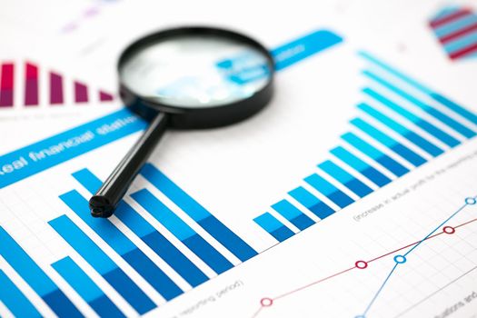 Financial statistics documents with lens at office table closeup. Internal Revenue Service inspector sum check, irs investigation, exchange market, earnings, savings, loan and credit concept