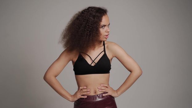 Denying, shields, stop and rejecting gesture African American young woman standing in black bare shoulder top isolated on grey background. Human emotions, facial expression concept.