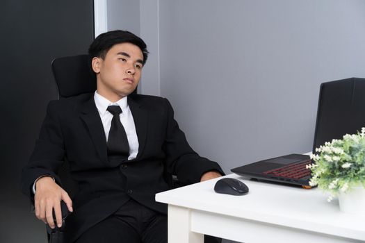 young business man sitting on chair and thinking