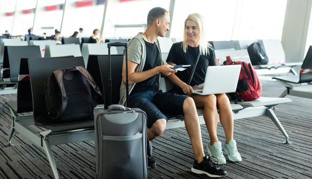 lovely couple with laptop at airport.