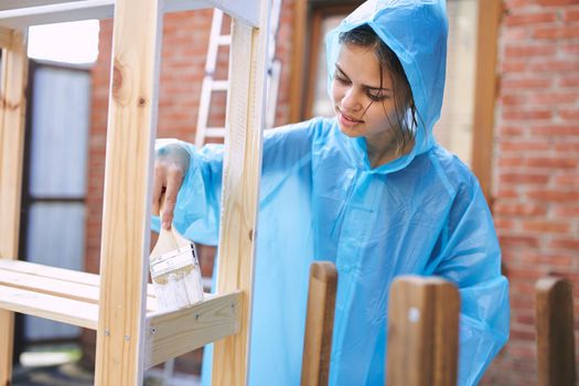 woman painter protective clothing wooden fittings renovation. High quality photo