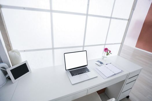 Modern interior workplace with laptop in white colors