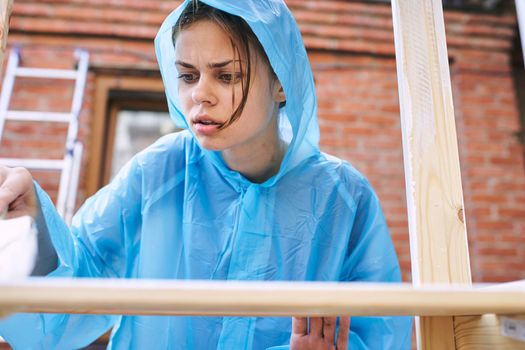 woman paints wood painter repair protective suit. High quality photo