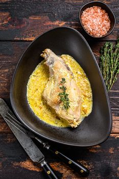 Stew with hare legs with rosemary and garlic. Wooden background. Top view.