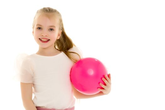 A charming little girl is engaged in fitness with a ball. The concept of gymnastics, health and sports. Isolated on white background.