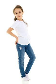 Beautiful Girl Standing with Hands on Her Waist, Cute Child in Blank White Shirt and Blue Jeans Standing Half Turn and Smiling at the Camera, Pretty Girl Posing Against White Studio Background