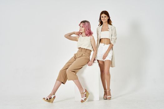 two models posing fashion friendship light background. High quality photo