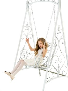 Beautiful Blonde Girl in Nice Lace Dress Sitting on White Elegant Metal Swing, Portrait of Lovely Cheerful Girl Wearing Fashionable Stylish Clothes Posing Against White Background